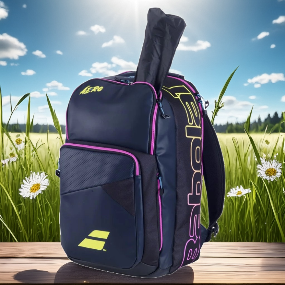 Backpack Pure Aero Rafa g2 Babolat displayed on a sunny day with greenery in the background.