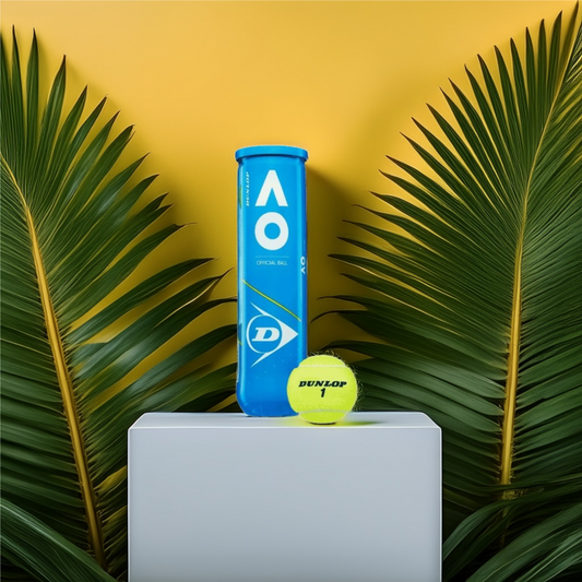 קרטון כדורי טניס Dunlop Australian Open (4 כדורים בקופסה) | דנלופ על רקע צמחייה טרופית.